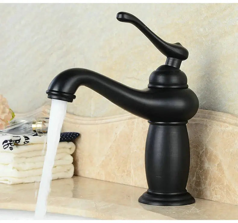 Antique bronze bathroom faucet with white ceramic ornate handle