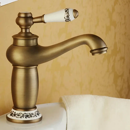 Antique bronze bathroom faucet with white ceramic ornate handle