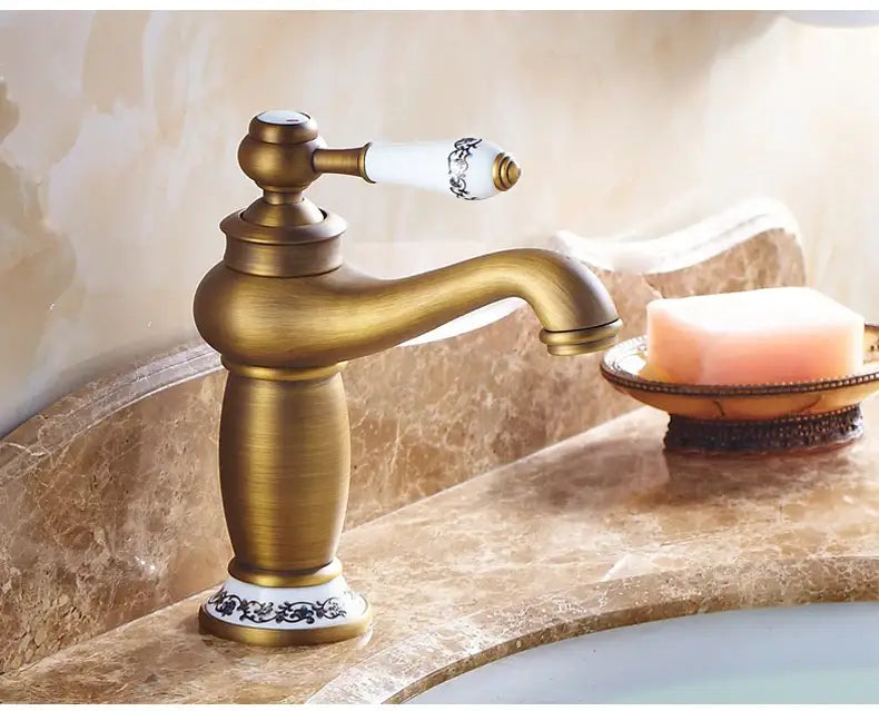 Antique bronze bathroom faucet with white ceramic ornate handle