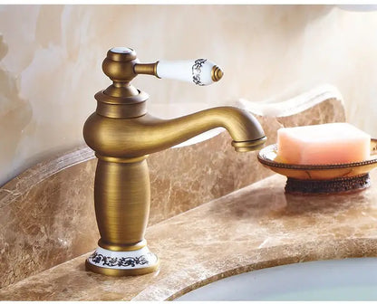Antique bronze bathroom faucet with white ceramic ornate handle