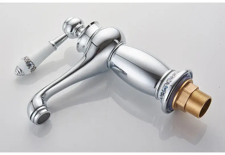 Antique bronze bathroom faucet with white ceramic ornate handle