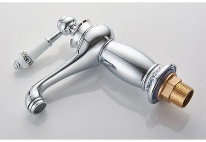 Antique bronze bathroom faucet with white ceramic ornate handle