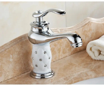 Antique bronze bathroom faucet with white ceramic ornate handle