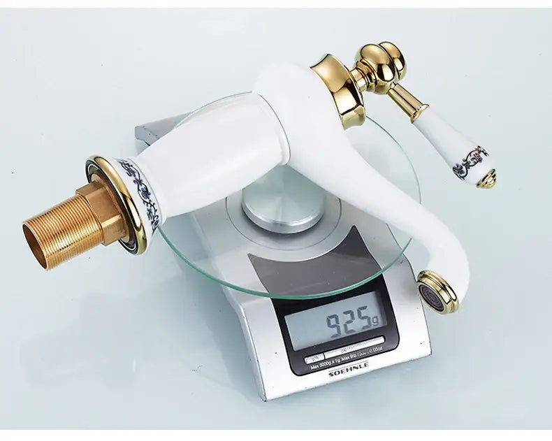 Antique bronze bathroom faucet with white ceramic ornate handle