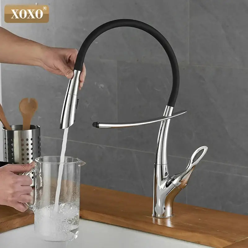 Arched brushed nickel kitchen faucet with black rubberized hose