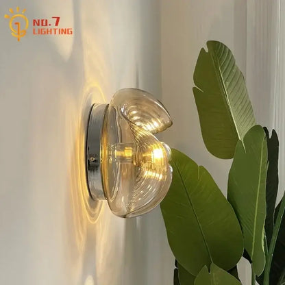 Bauhaus wavy glass wall lamp for bedroom clear and metallic light