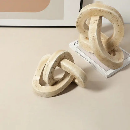 Beige speckled geometric interlocking loop knot living room sculpture