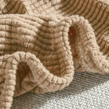 Beige textured quilted sofa cover with pillows for living room