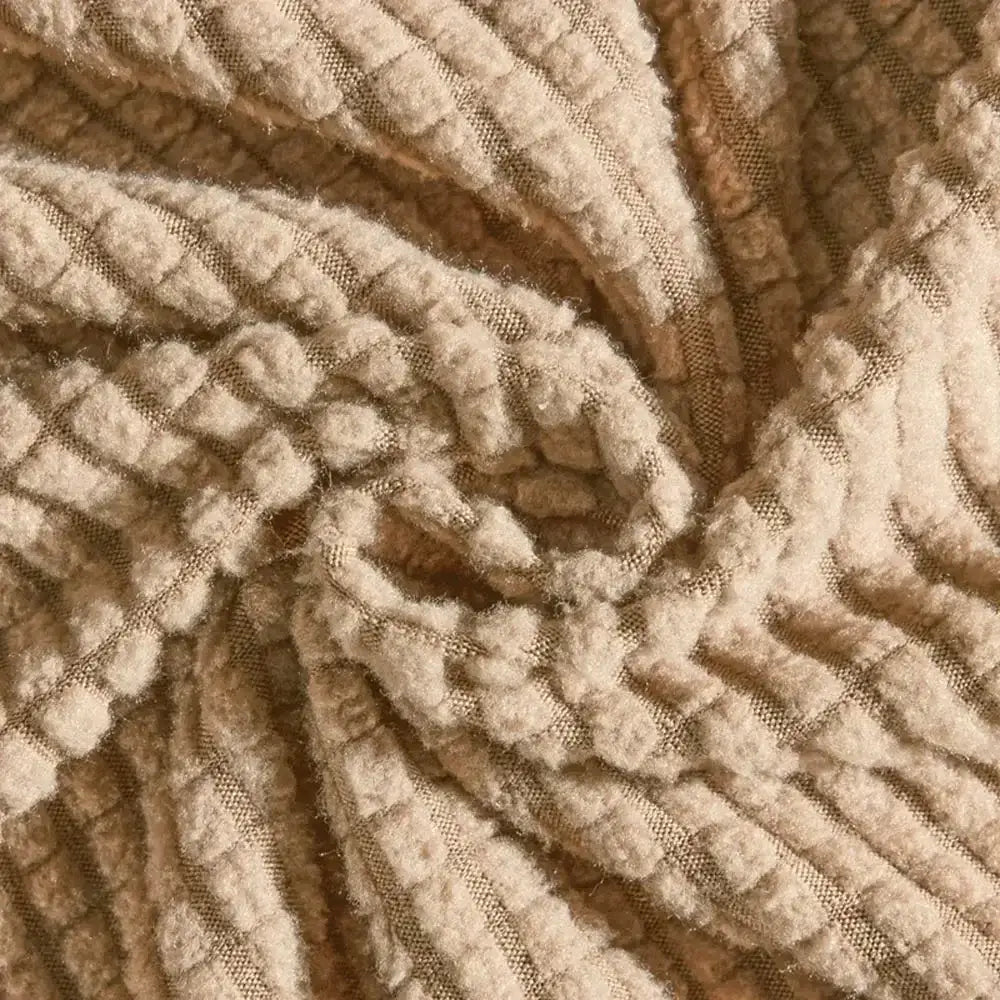 Beige textured quilted sofa cover with pillows for living room