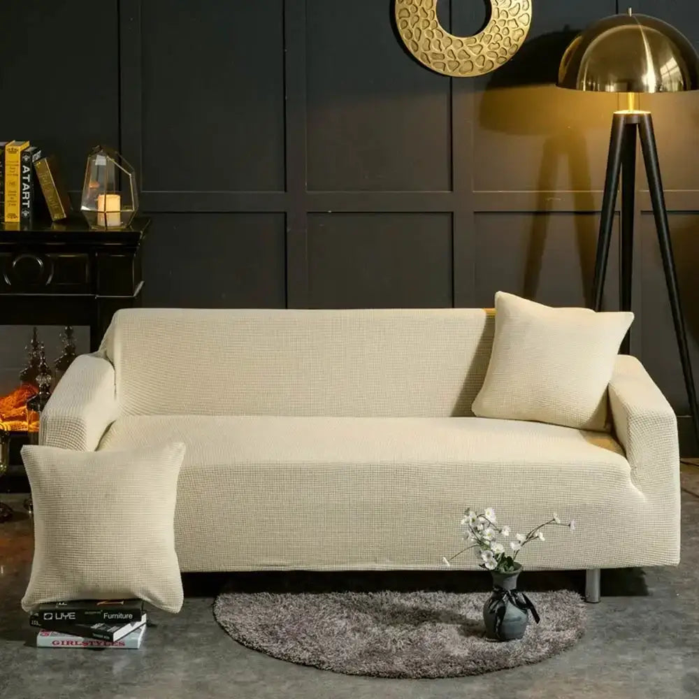 Beige textured quilted sofa cover with pillows for living room