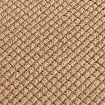 Beige textured quilted sofa cover with pillows for living room