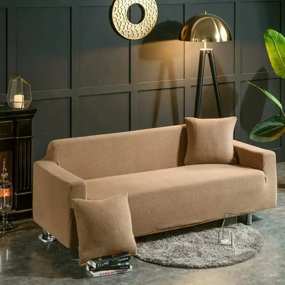 Beige textured quilted sofa cover with pillows for living room