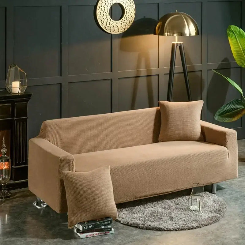 Beige textured quilted sofa cover with pillows for living room