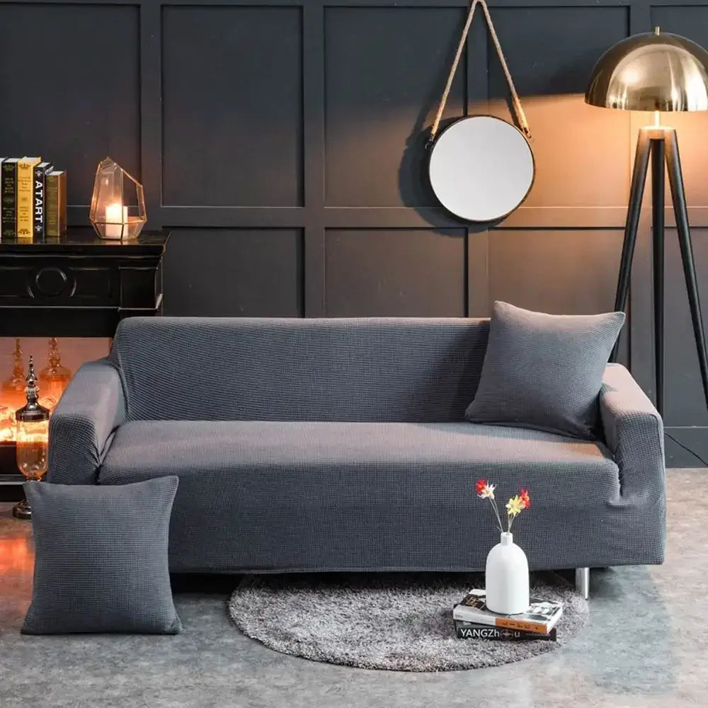 Beige textured quilted sofa cover with pillows for living room
