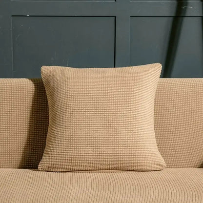 Beige textured quilted sofa cover with pillows for living room