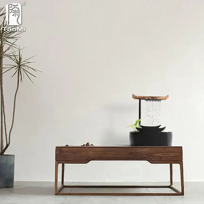 Black ceramic water fountain with wood roof living room decor