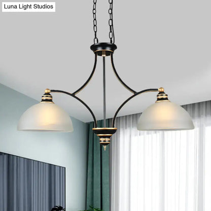 Black and gold dome chandelier with white glass shades dining room
