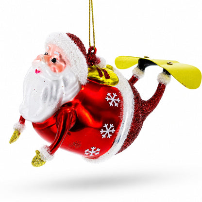 Santa Snowboarding Glass Christmas Ornament