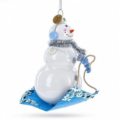 Snowman Riding a Sled Glass Christmas Ornament