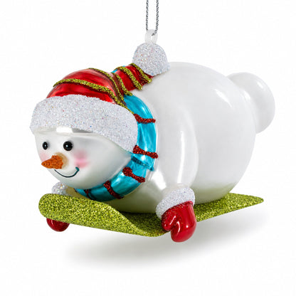 Snowman Gleefully Riding a Sled Glass Christmas Ornament