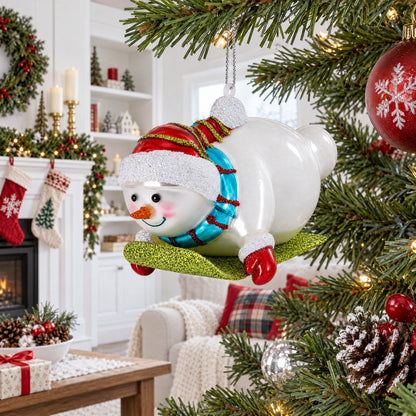 Snowman Gleefully Riding a Sled Glass Christmas Ornament