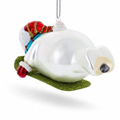 Snowman Gleefully Riding a Sled Glass Christmas Ornament
