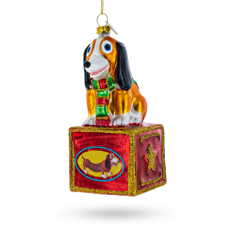 Playful Toy Dog on Festive Red Box Glass Christmas Ornament