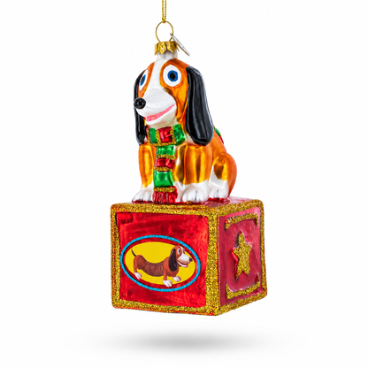 Playful Toy Dog on Festive Red Box Glass Christmas Ornament