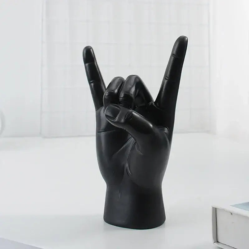 Chic black glossy rock hand gesture sculpture living room decor