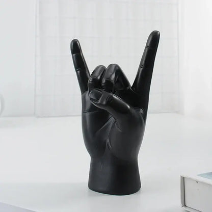 Chic black glossy rock hand gesture sculpture living room decor
