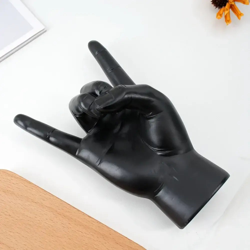 Chic black glossy rock hand gesture sculpture living room decor