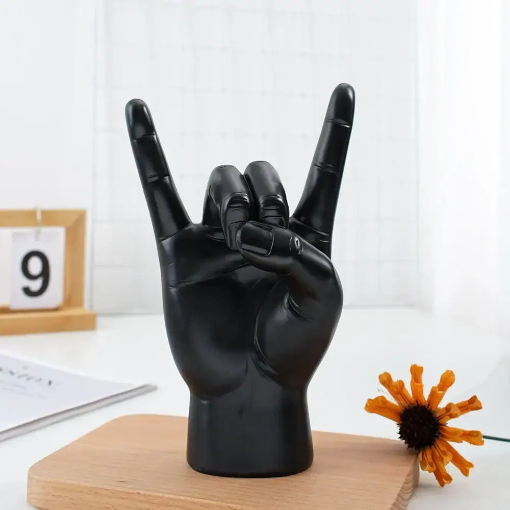 Chic black glossy rock hand gesture sculpture living room decor
