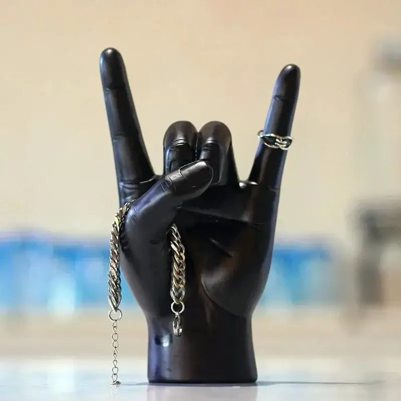 Chic black glossy rock hand gesture sculpture living room decor