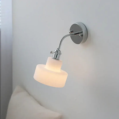 Chrome adjustable arm wall lamp with ribbed glass shade – bedroom