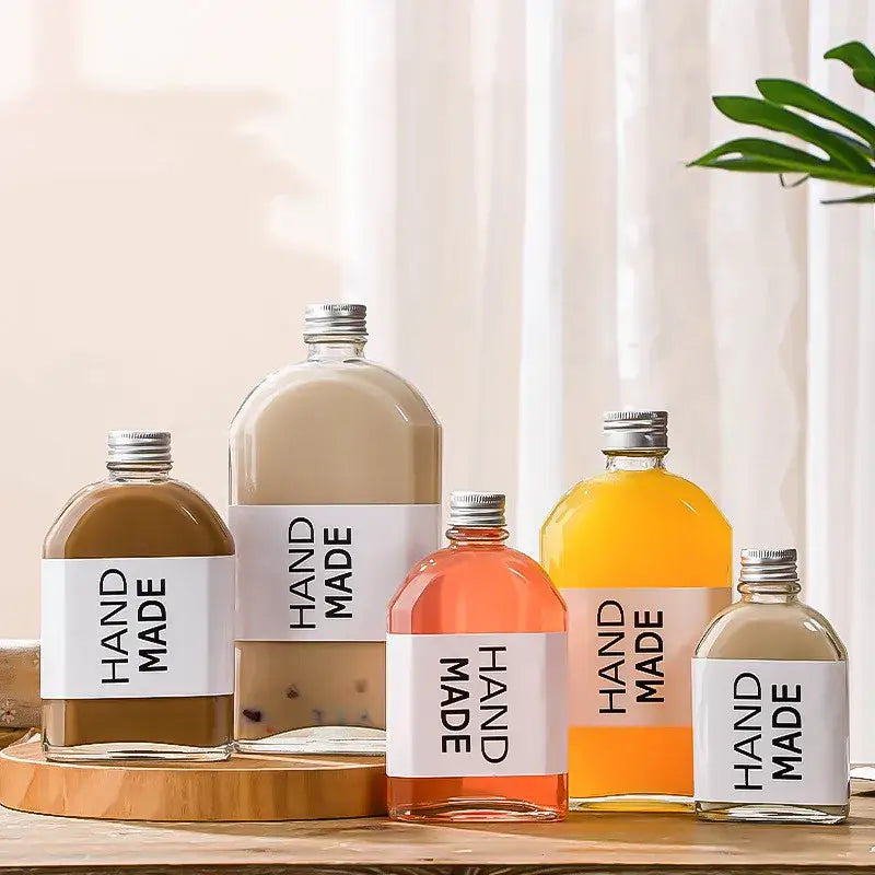 Clear glass beverage bottles with silver caps – kitchen juicing set
