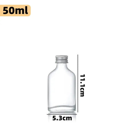Clear glass beverage bottles with silver caps – kitchen juicing set