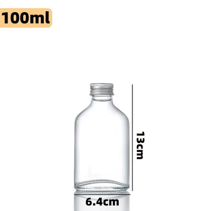 Clear glass beverage bottles with silver caps – kitchen juicing set