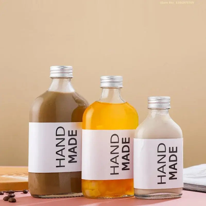 Clear glass beverage bottles with silver caps – kitchen juicing set