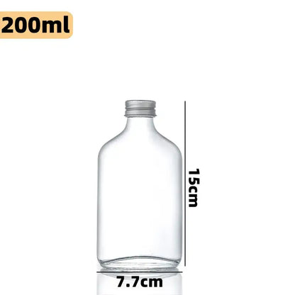 Clear glass beverage bottles with silver caps – kitchen juicing set