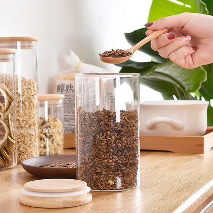 Clear glass storage jars with bamboo lids for kitchen organization
