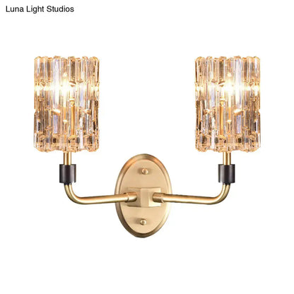 Contemporary brass bedside wall sconce with clear crystal shade bedroom