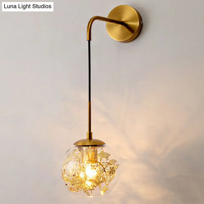 Contemporary brass clear glass wall lamp with foil flower decor bedroom