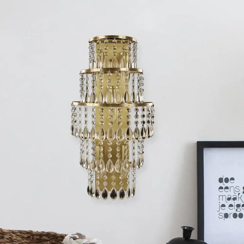 Contemporary gold layered bedside wall lamp with teardrop crystals