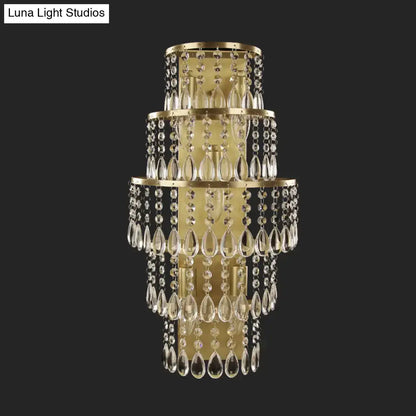 Contemporary gold layered bedside wall lamp with teardrop crystals