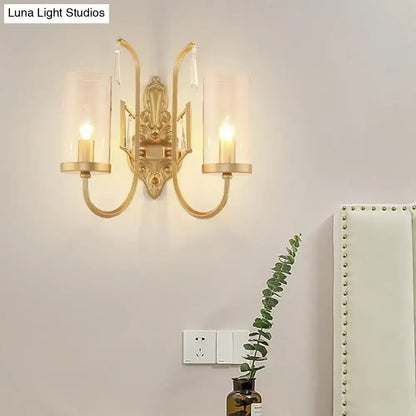 Contemporary gold wall light bedroom sconce with clear glass shade