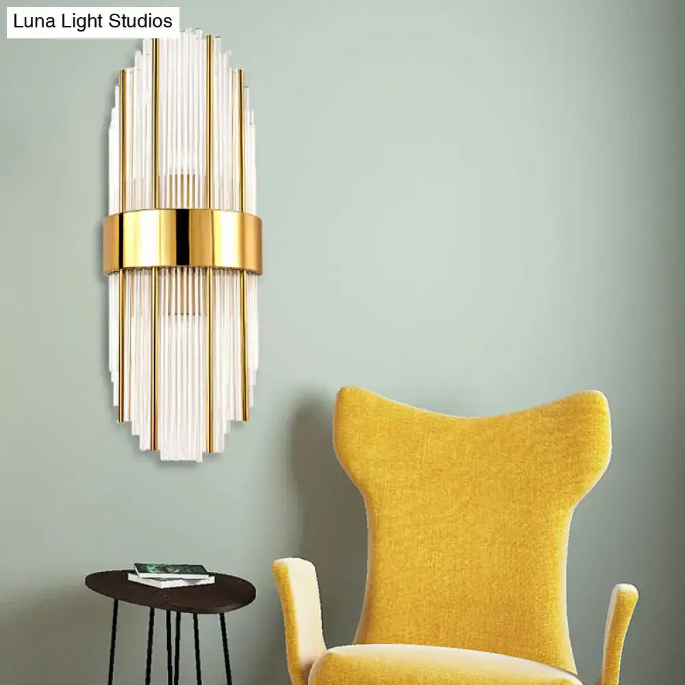 Contemporary gold wall light with clear crystal shade – living room