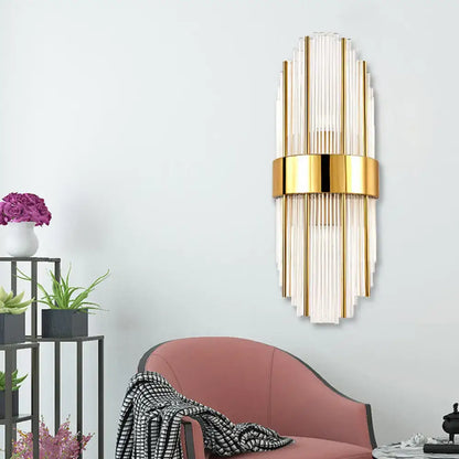 Contemporary gold wall light with clear crystal shade – living room