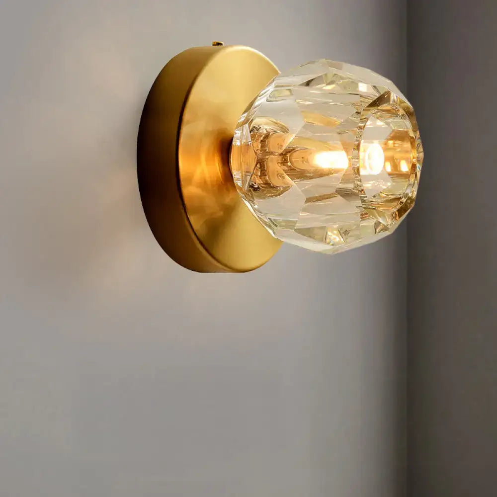 Contemporary golden wall mount lamp with faceted glass shade living room
