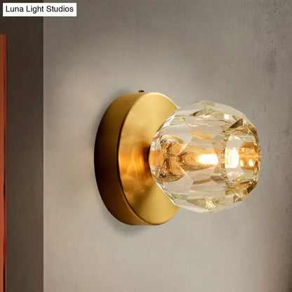 Contemporary golden wall mount lamp with faceted glass shade living room