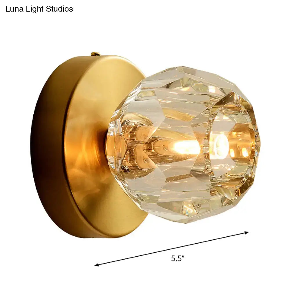 Contemporary golden wall mount lamp with faceted glass shade living room
